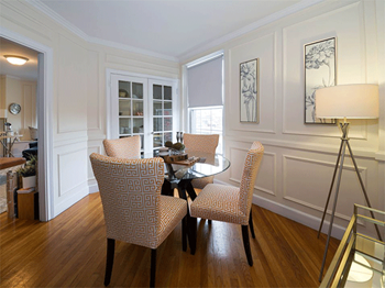a dining room with a table and chairs